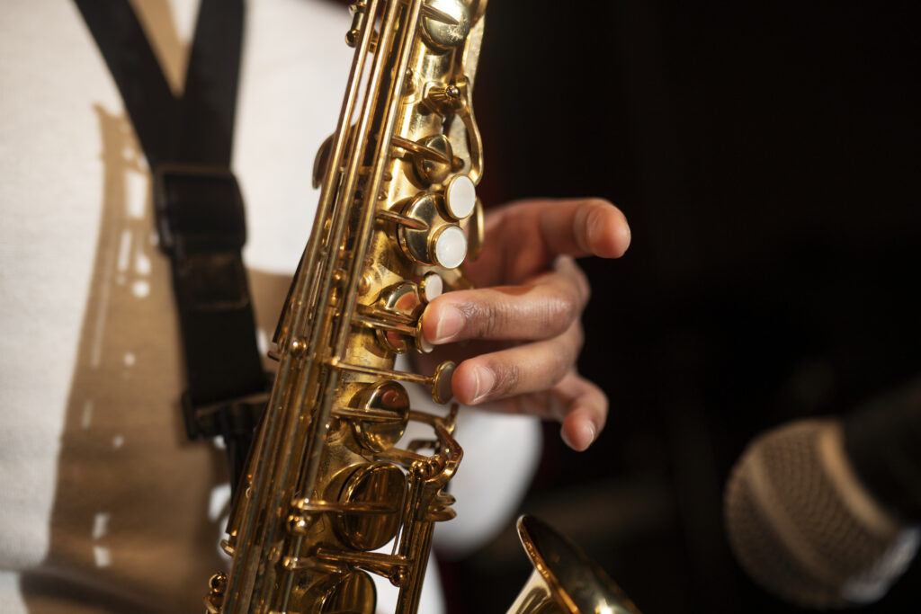 close up hand playing saxophone